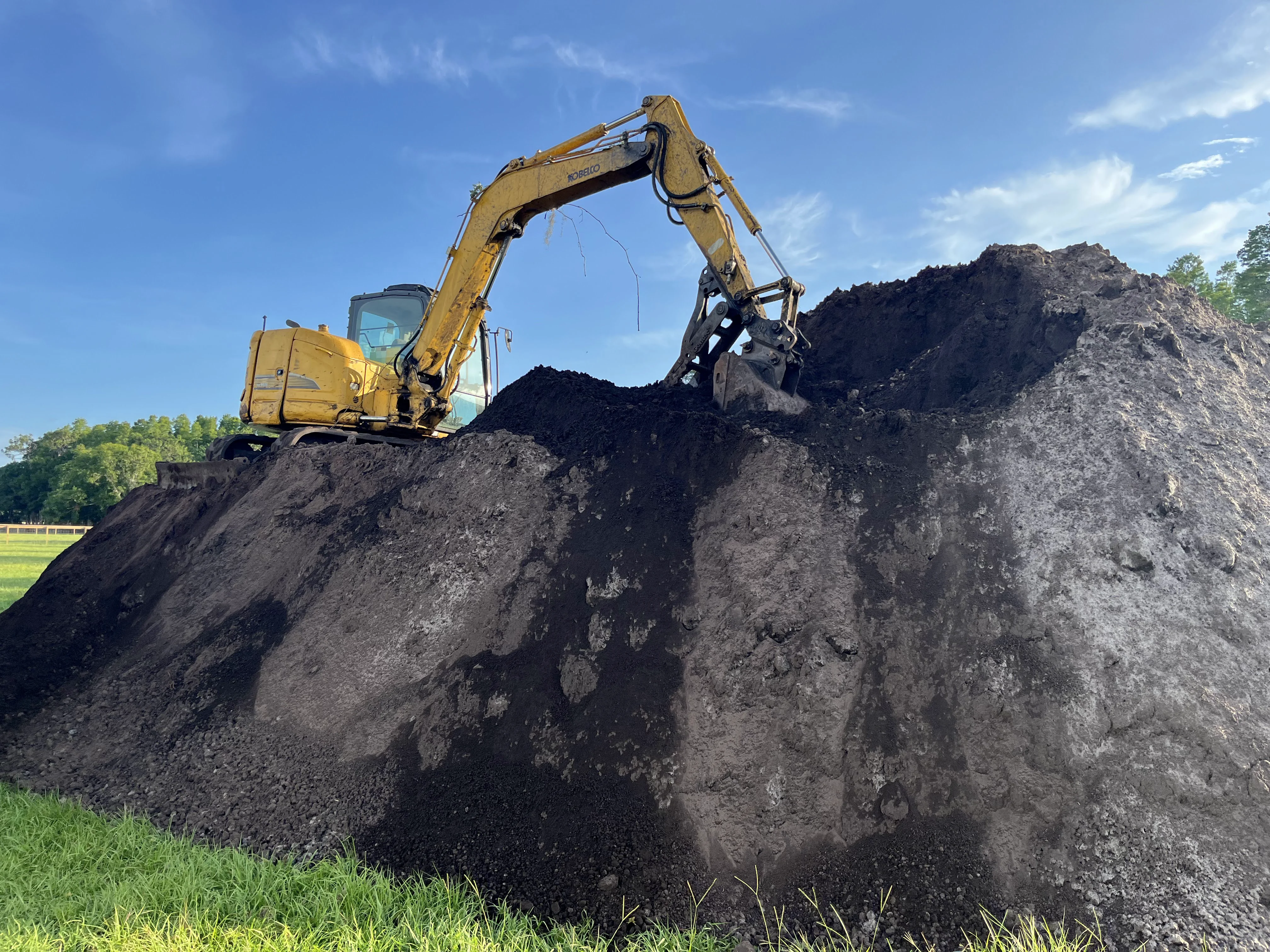 Excavator on a Pile of Dirt