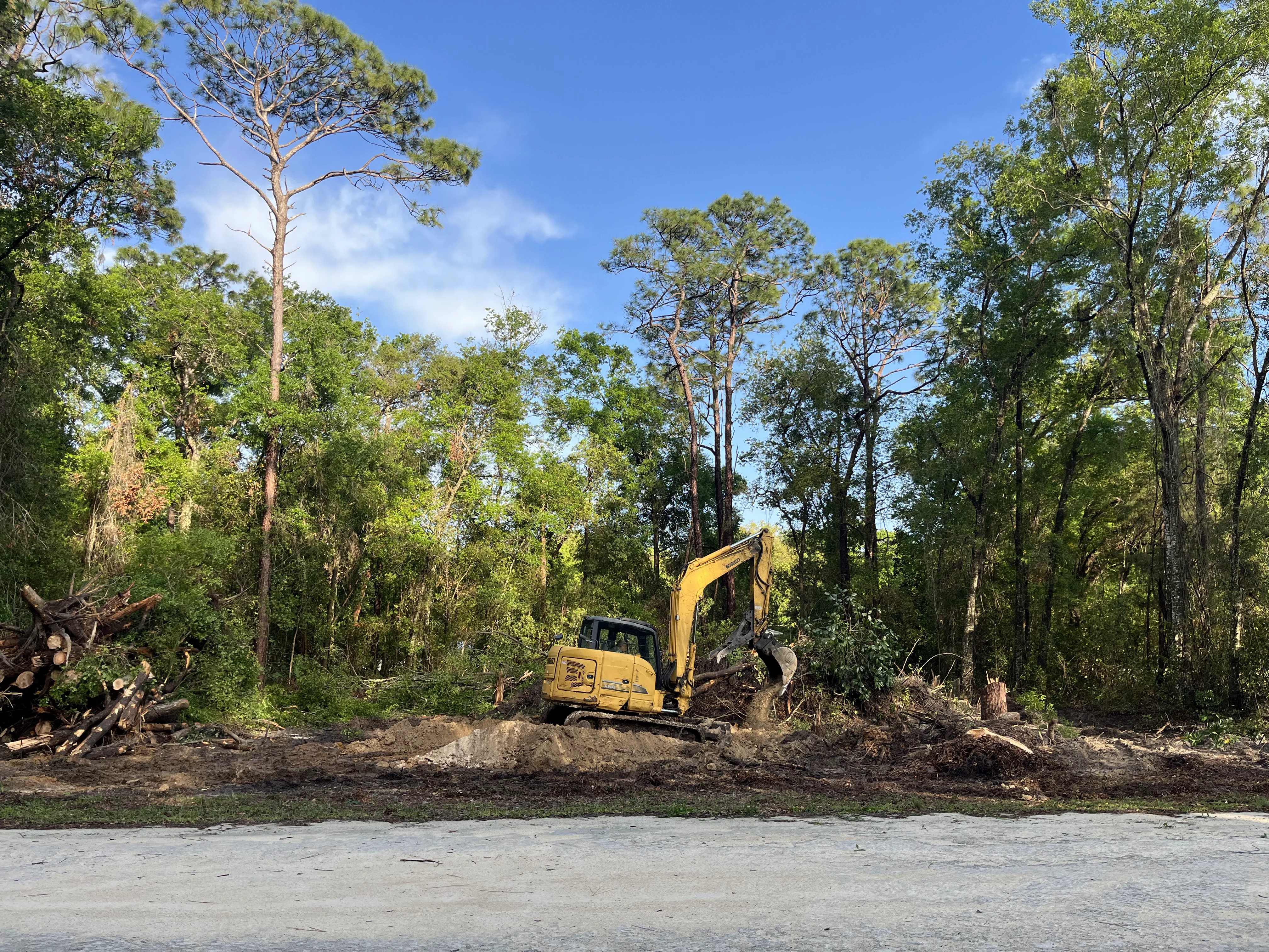 Excavator Clearing Land